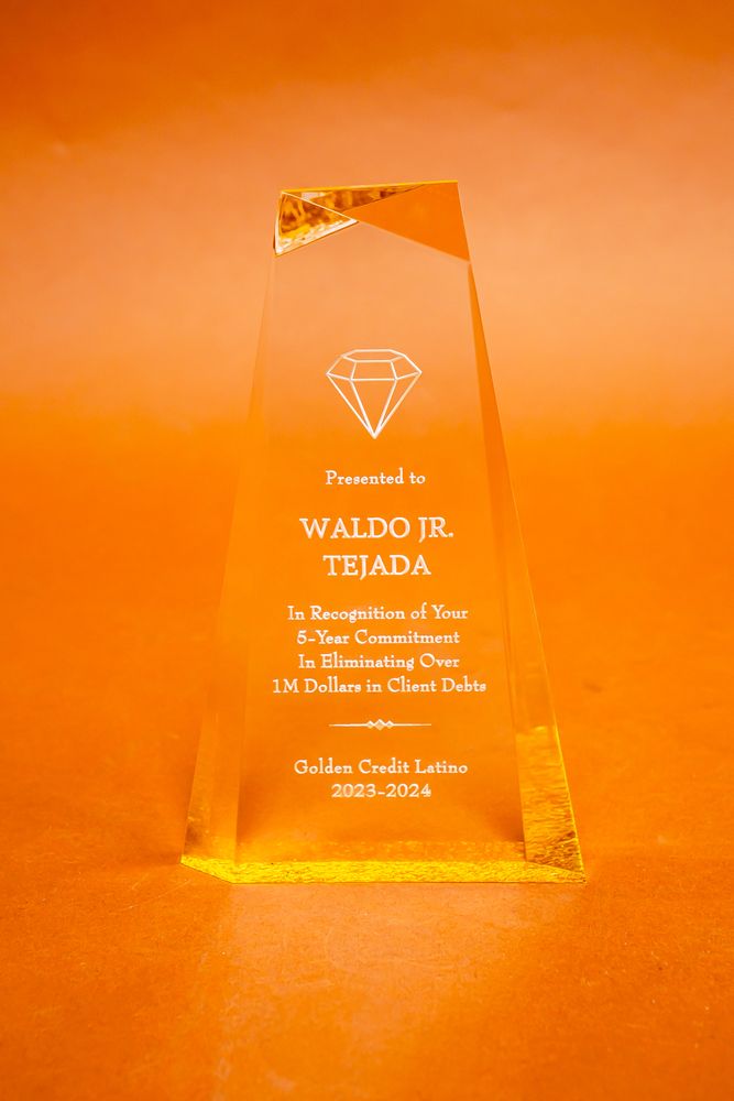 An orange award featuring the name "Waldo J. Teda" prominently displayed on its surface.