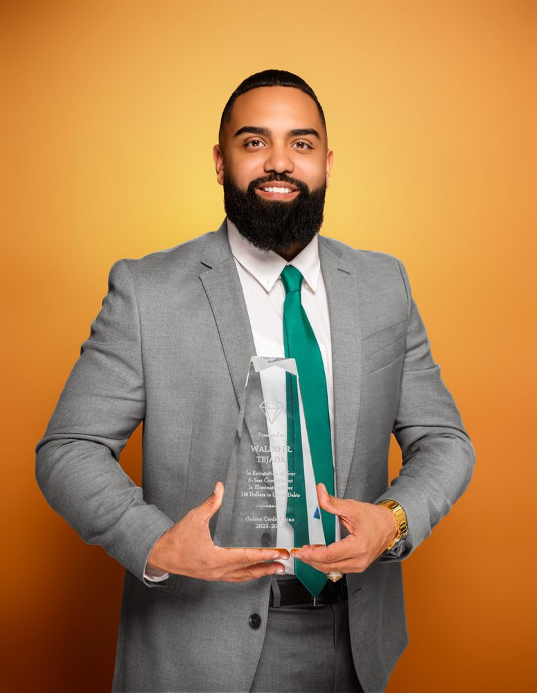 A bearded man in a green tie proudly holds an award, showcasing his achievement and professionalism.