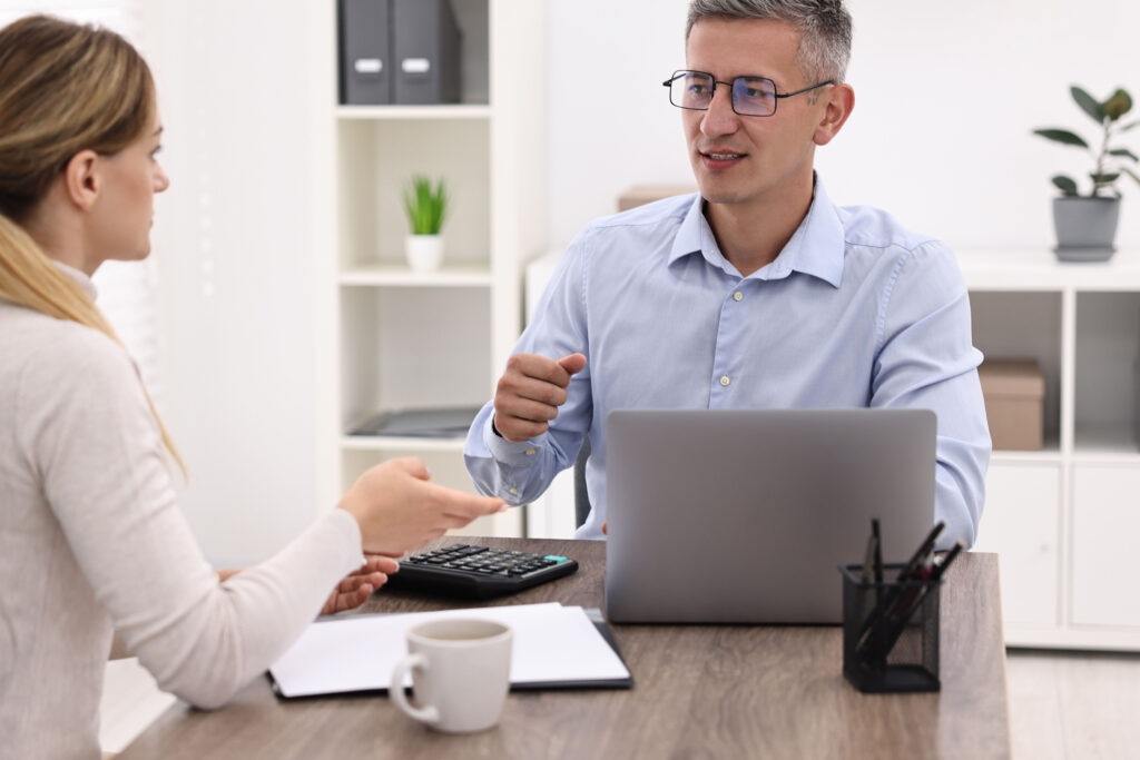 Advisor discussing debt consolidation strategies with a client in an office setting.