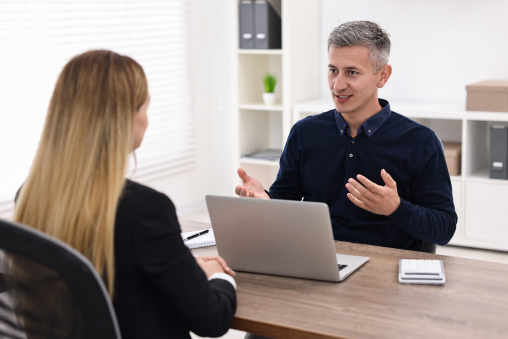 Financial advisor discussing debt consolidation with a client in an office setting.